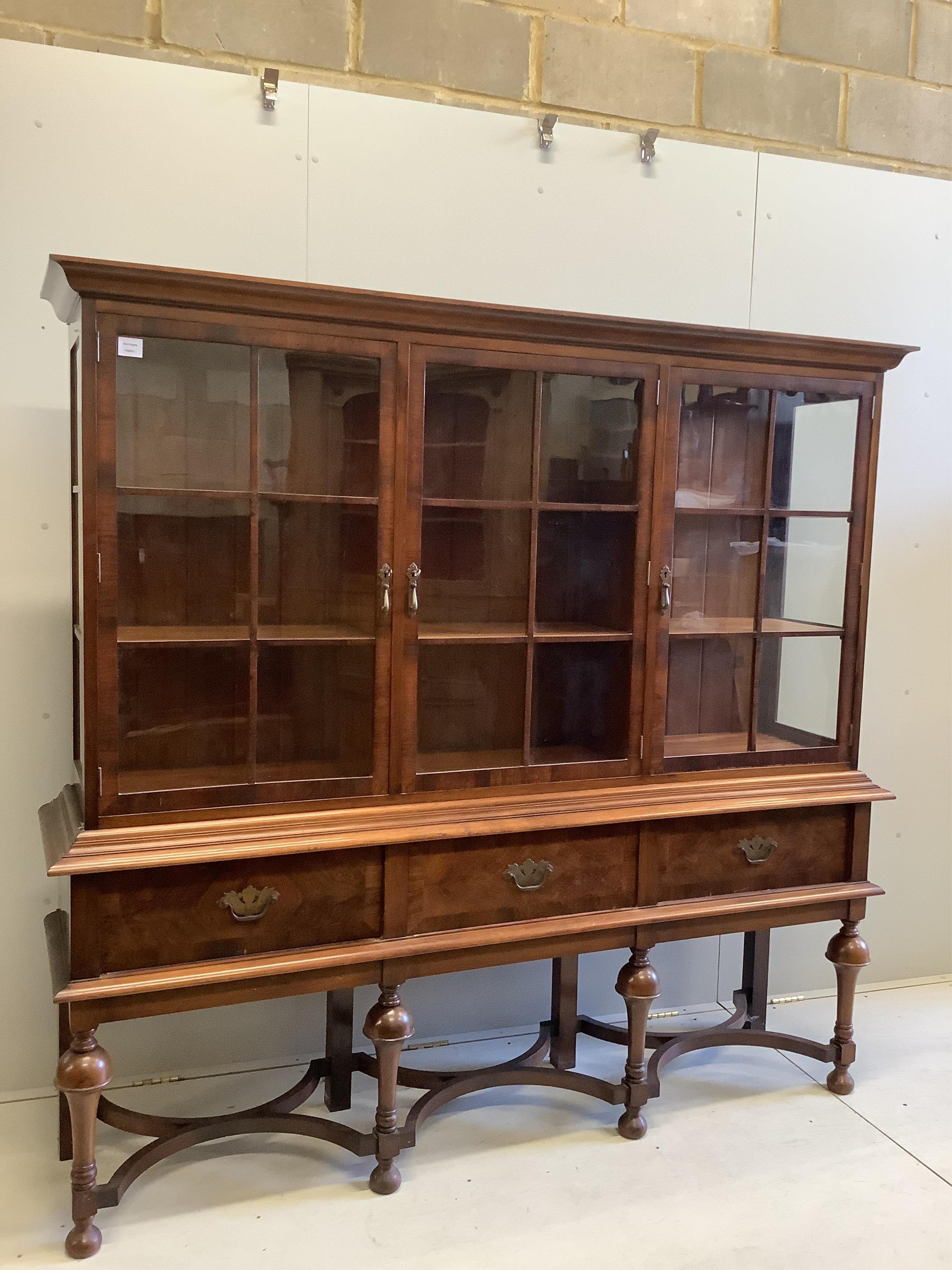 An early 20th century Dutch style walnut display cabinet, width 188cm, depth 44cm, height 180cm. Condition - fair to good